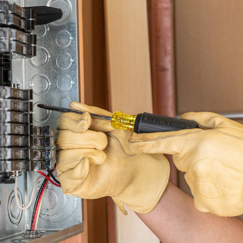 Klein Tools 85664 4pc Square-Recess Round Shank Screwdriver Set showing in use fastening screws into breaker box