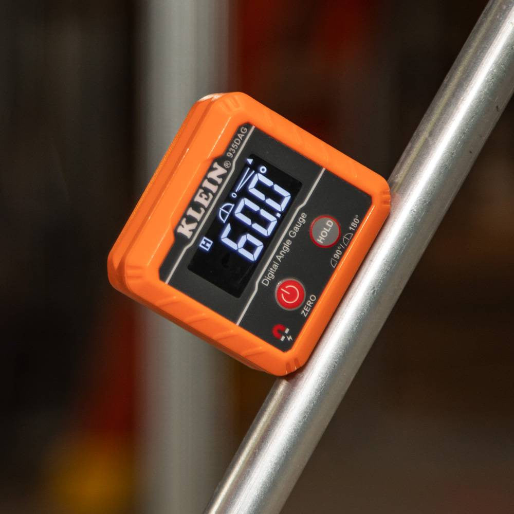 Klein Tools 935DAG Digital Angle Gauge and Level showing in use reading angle of conduit