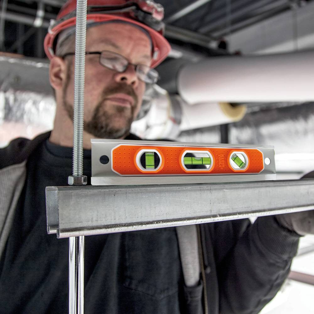 Klein Tools 935R 9-inch Aluminum Rare-Earth Magnet Torpedo Billet Level showing in use levelling a bracket hung by ready-rod