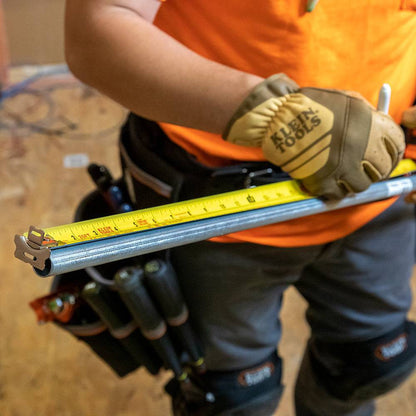 Klein Tools 9375 25-feet/7.5-meter Magnetic Double-Hook Tape Measure showing in use measuring a length of metal conduit