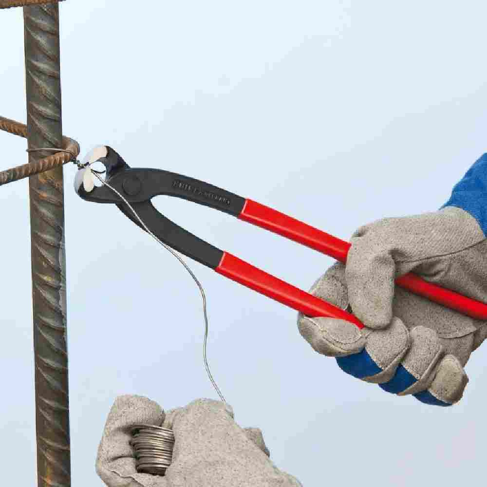 Knipex 9901220SBA 8-3/4 inch Concreters' Nippers showing in use while twisting before cutting wire