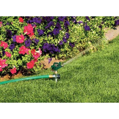 Holland Greenhouse S010650N Pulsating Impact Sprinkler with Brass Spike showing in use watering a lawn