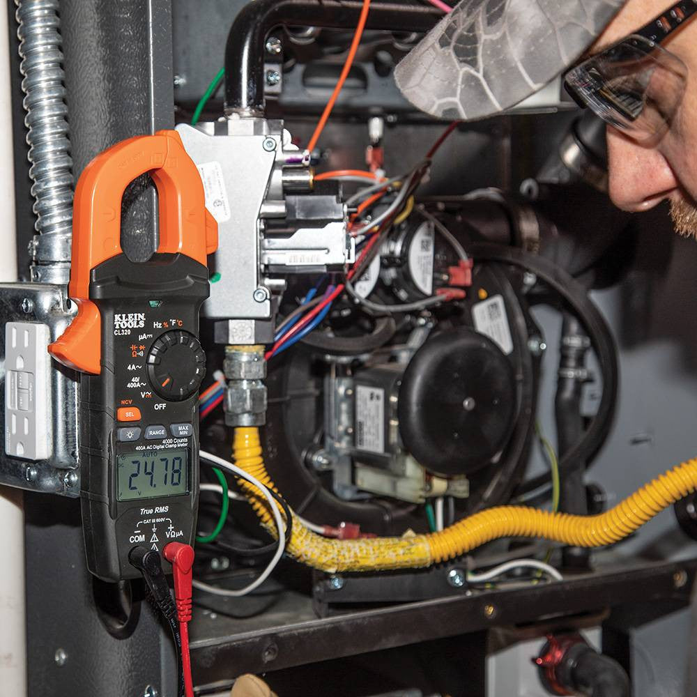 Klein Tools CL320 400 Amp HVAC Digital Clamp Meter  showing in use testing voltage with leads