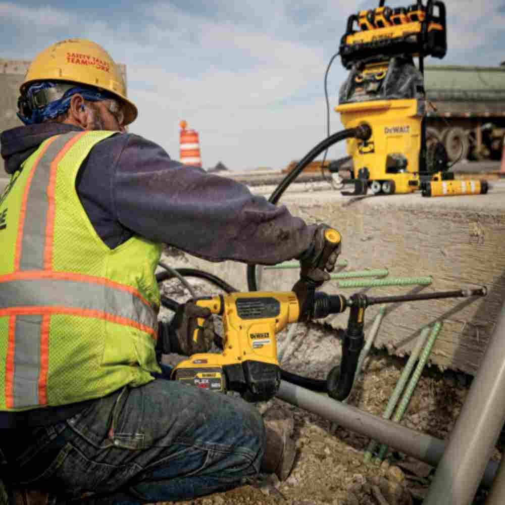 DeWalt DCB1800B 1800 Watt Portable Power Station and Simultaneous Battery Charger (Tool Only) showing in use running vacuum and hammer drill (Sold Separately)