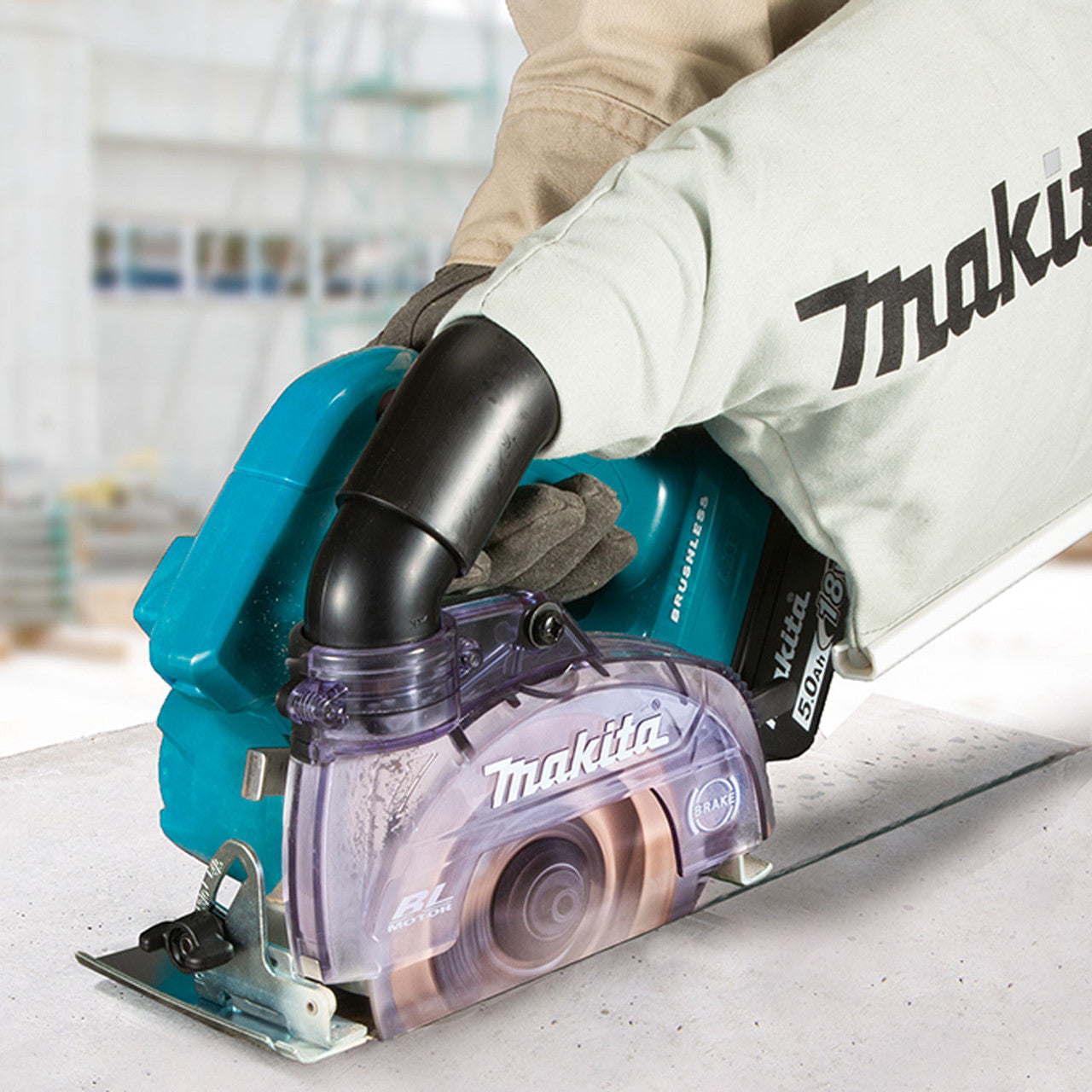 Makita DCC500ZX1 18V LXT Cordless Brushless 5 inch Wet/Dry Masonry Saw (Tool Only) showing in use cutting a floor tile