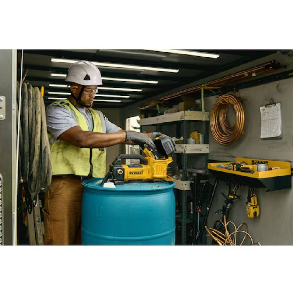 DeWalt DCE050B 20V MAX Cordless Transfer Pump (Tool Only) showing being battery being installed while sitting on a barrel (Battery sold separately)