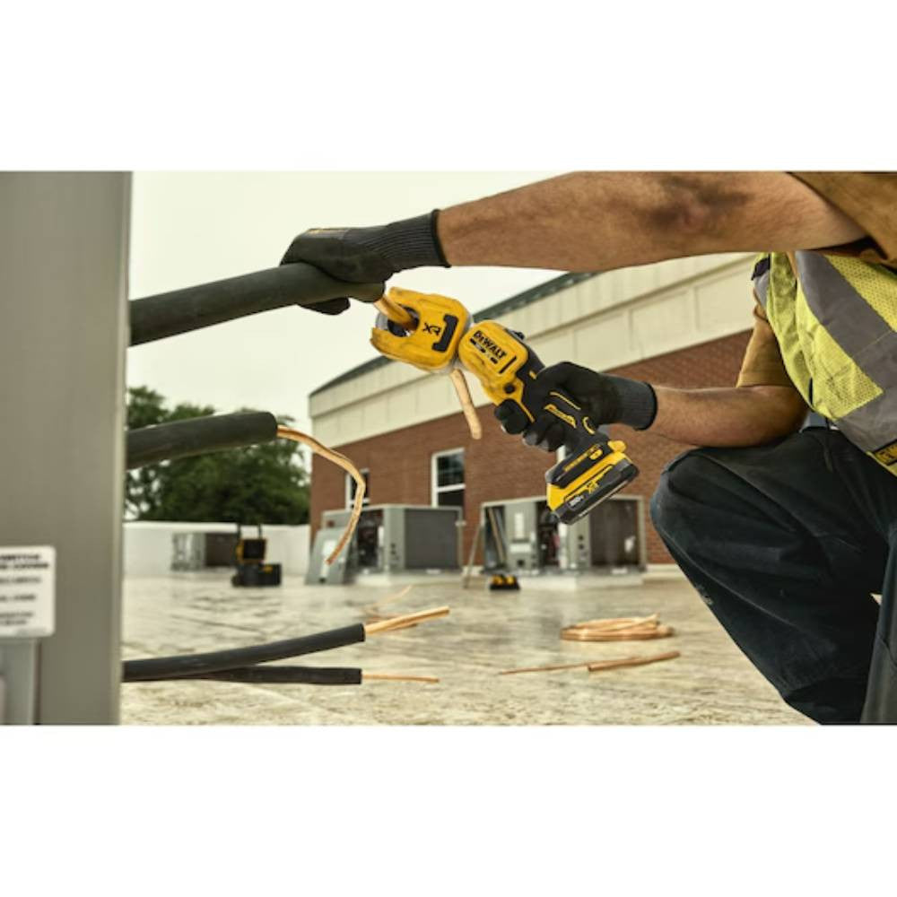 DeWalt DCE154B 20V MAX XR Cordless 1-1/4in Copper Tubing Cutter (Tool Only) showing in use cutting copper pipe coming out of a wall while partial articulating head (Battery sold separately)