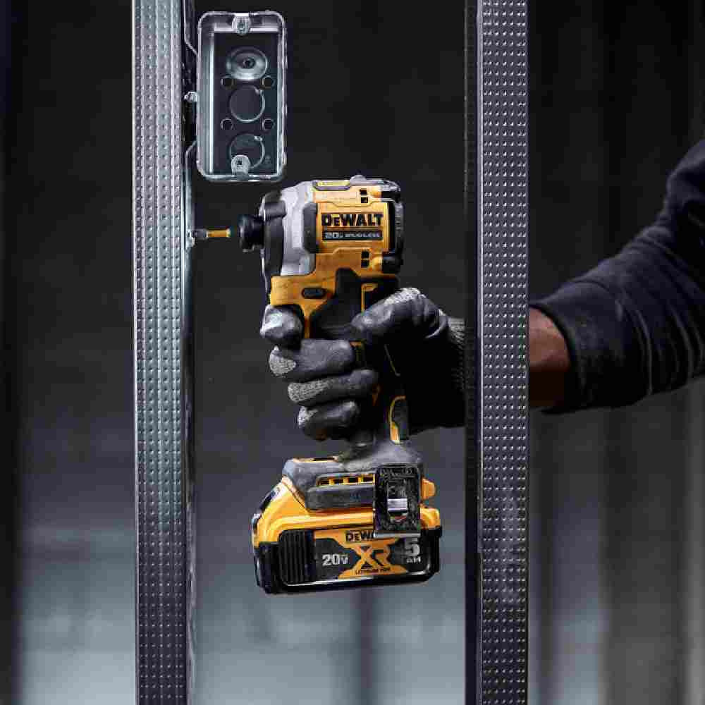 DeWalt DCF850P1 ATOMIC 20V MAX Cordless Brushless 3-Speed 1/4 inch Impact Driver Kit showing in use driving screw into steel stud fastening electrical box to stud