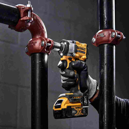 DeWalt DCF922B ATOMIC 20V MAX Cordless Brushless 1/2 inch Impact Wrench with Detent Pin Anvil (Tool Only) showing in use fastening bolts to secure pipe fittings together
