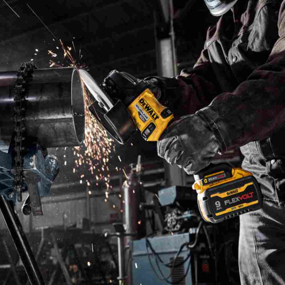 DeWalt DCG440B FLEXVOLT 60V MAX 7 inch Cordless Brushless Grinder With Kickback Brake (Tool Only) showing in use grinding black iron piping