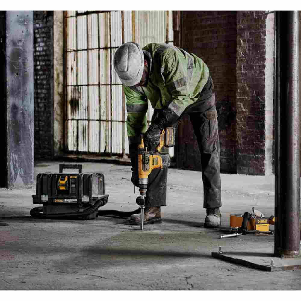DeWalt DCH416X2 60V MAX Cordless Brushless SDS PLUS 1-1/4 inch Rotary Hammer Kit showing in use drilling vertically downward into concrete floor with vacuum attached (vacuum sold separately)