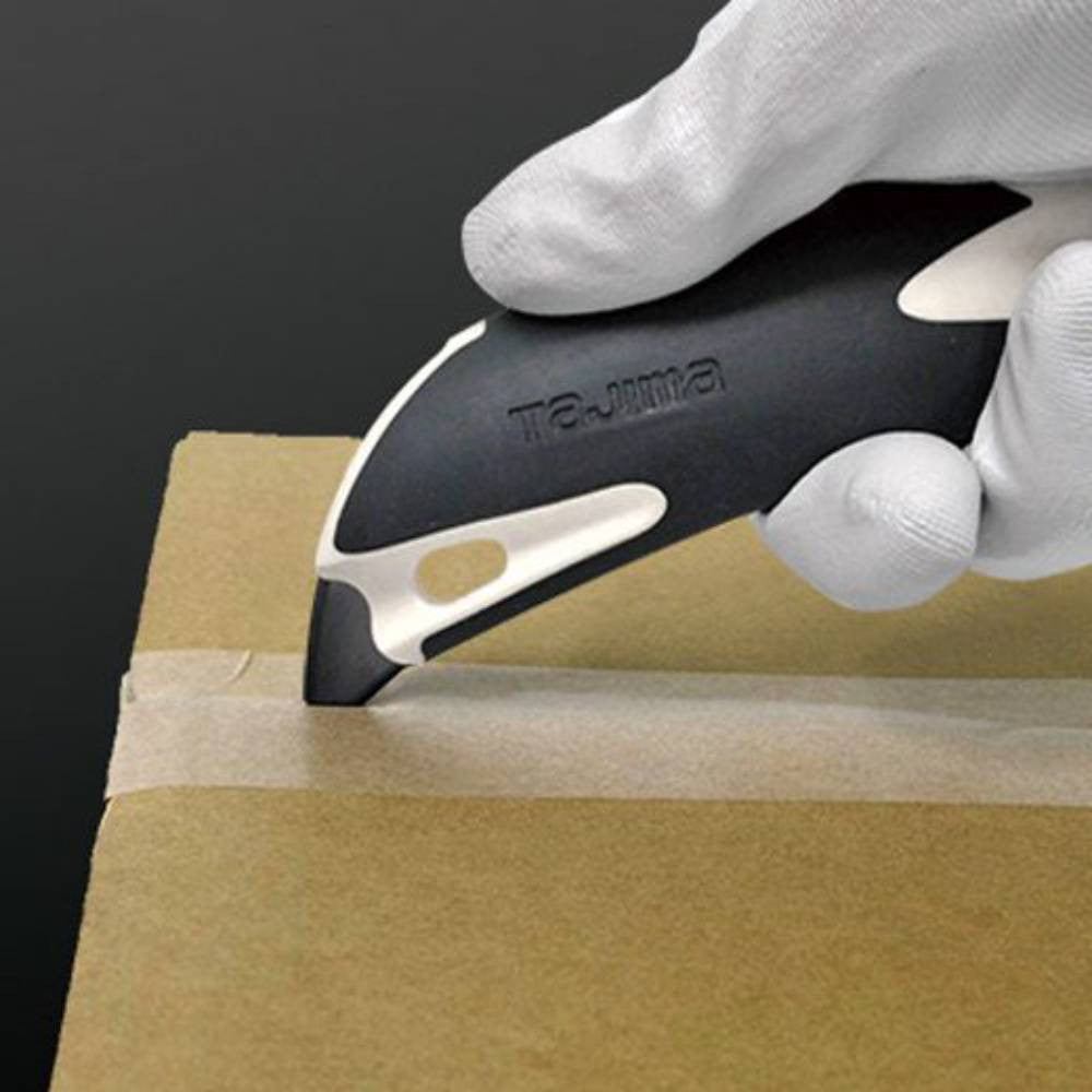 Tajima DFC560N Premium Cutter Series 560 Utility Knife with Auto-Lock showing in use cutting open a box