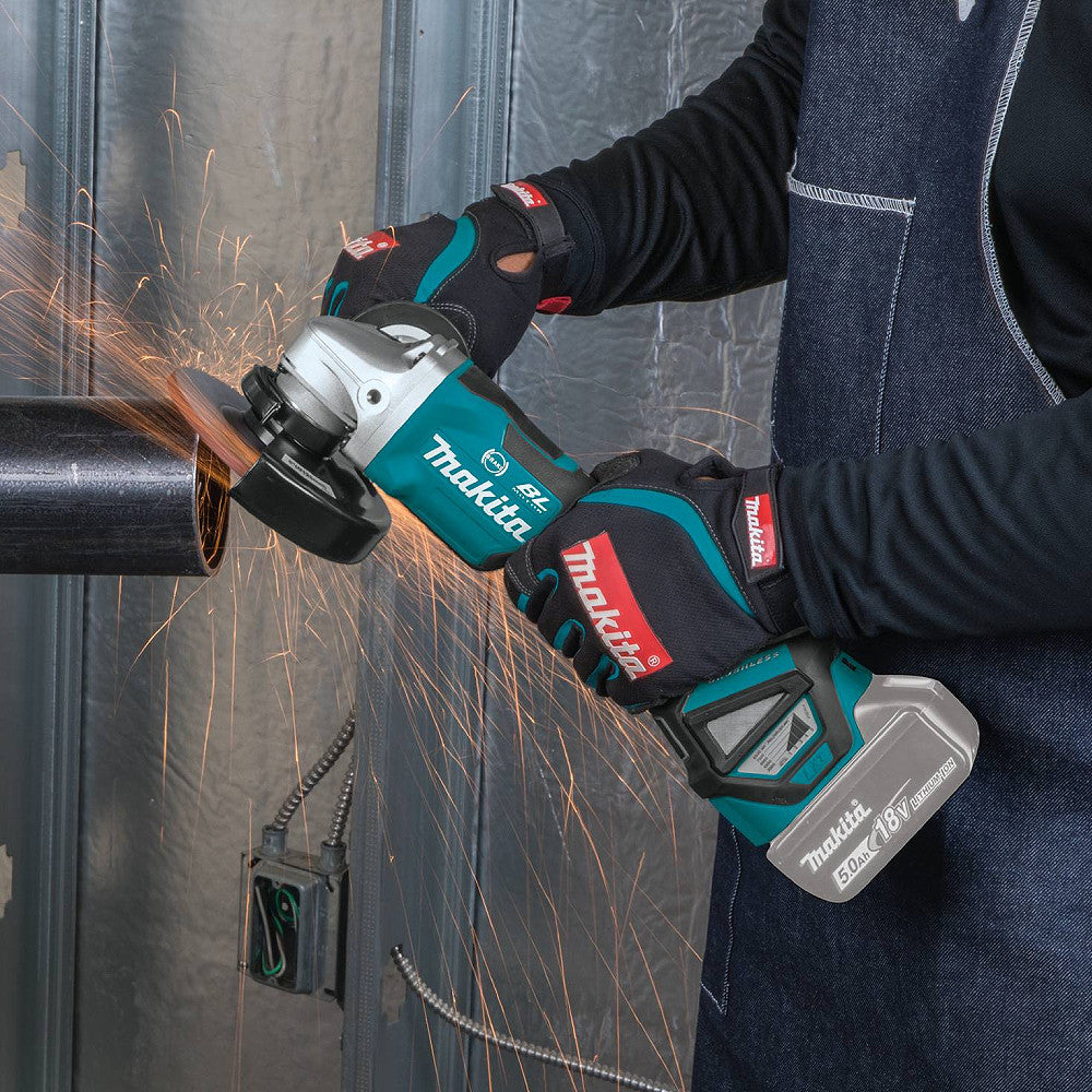 Makita DGA517Z 18V LXT Cordless Brushless 5 inch Angle Grinder with Paddle Switch (Tool Only) showing in use grinding edges of a freshly cut steal pipe