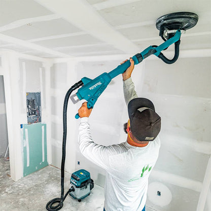 Makita DSL801ZX1 18V Brushless 8-7/8in Drywall Sander (Tool Only) showing in use sanding a ceiling with a vacuum connected (Battery & vacuum are sold separately)