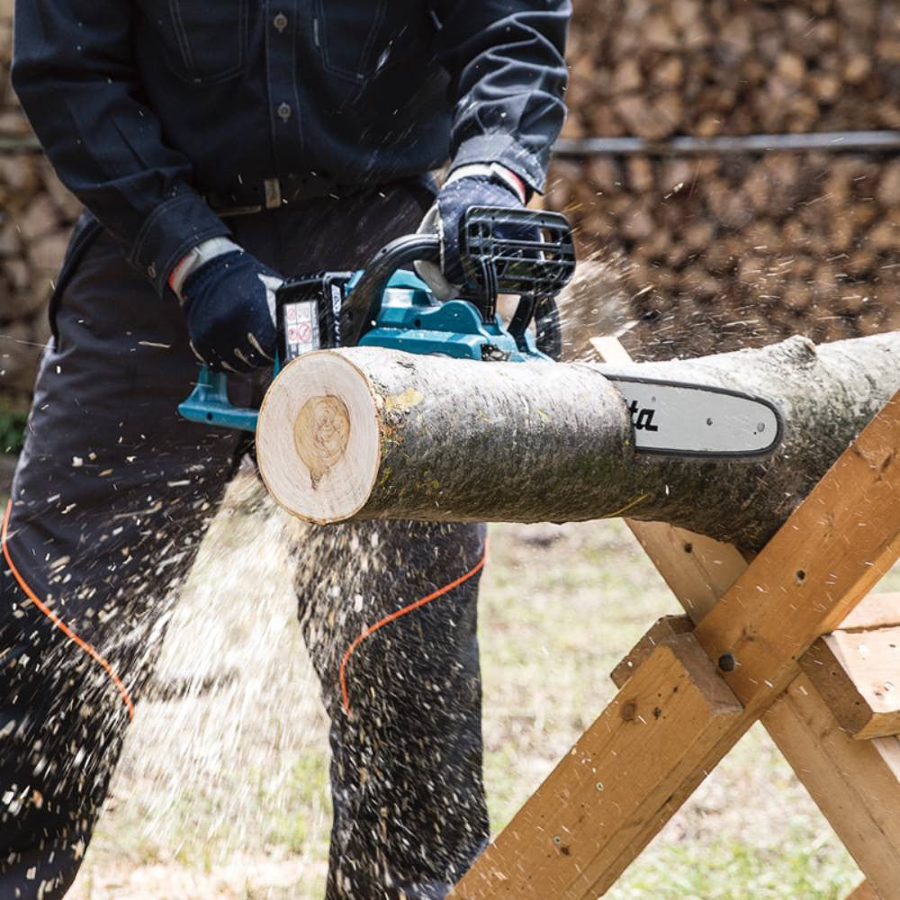 Makita DUC400Z 18Vx2 LXT 16 inch Brushless Rear Handle Chainsaw (Tool Only) showing in use cutting a log while sitting on a stand (Battery sold separately)
