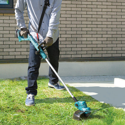 Makita DUR193Z 18V LXT Cordless 10-1/4 inch Line Trimmer (Tool Only) showing in use cutting grass along the side of a walk way