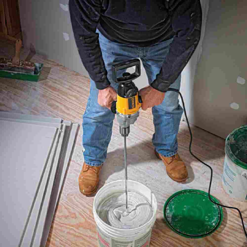 DeWalt DW130V 9 Amp 1/2 inch Spade Handle Drill showing in use mixing drywall mud in a bucket