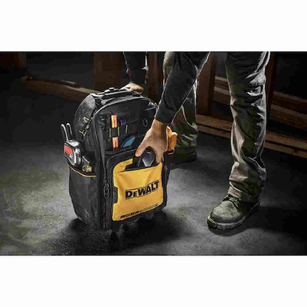 DeWalt DWST560101 Professional Backpack on Wheels showing on jobsite with contractor retrieving tools from the front pocket (Tools sold separately)