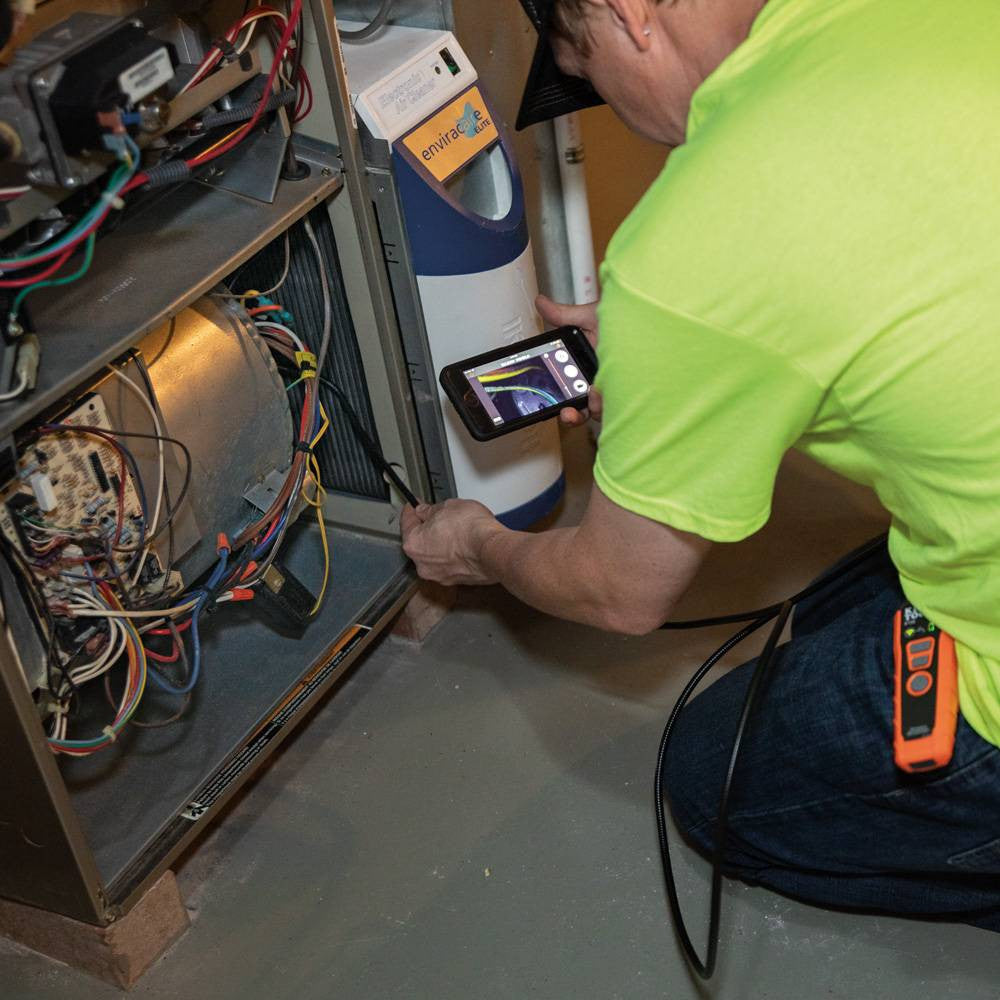 Klein Tools ET20 WiFi Borescope showing in use looking on the inside of a furnace