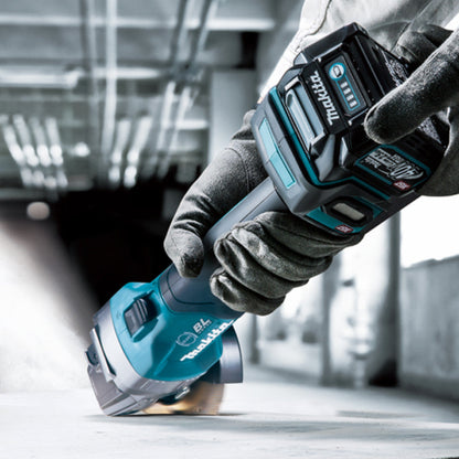 Makita GA005GZ 40V XGT Cordless Brushless 5 inch Angle Grinder - Slide Switch (Tool Only) showing in use cutting into a concrete floor