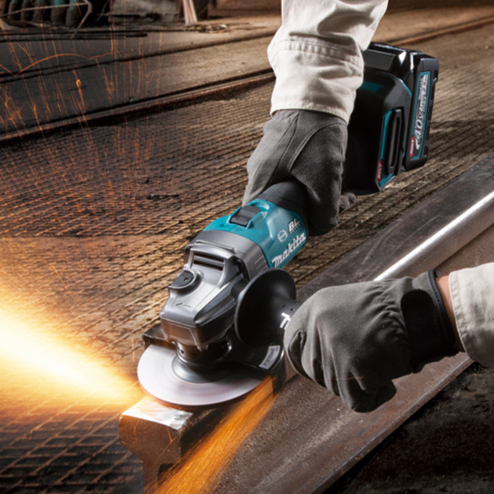 Makita GA005GZ 40V XGT Cordless Brushless 5 inch Angle Grinder - Slide Switch (Tool Only) showing in use grinding down an 'I-Beam' to clean it up and ensures it fits