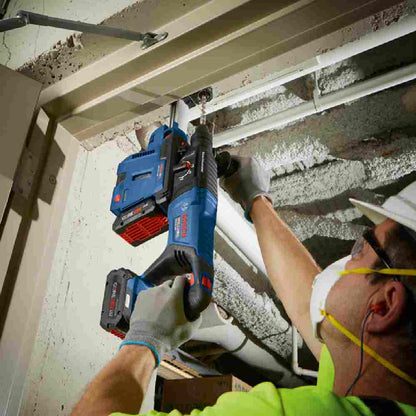 Bosch GBH18V-26DN 18V EC Cordless Brushless SDS-Plus Bulldog 1 inch Rotary Hammer (Tool Only) showing drilling in ceiling through steel stud with dust extractor (Sold Separately)