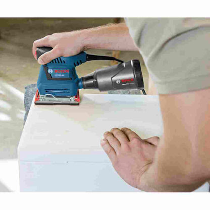 Bosch GSS20-40 2 Amp 1/4-Sheet Orbital Finishing Sander showing sanding with included dust bag showing