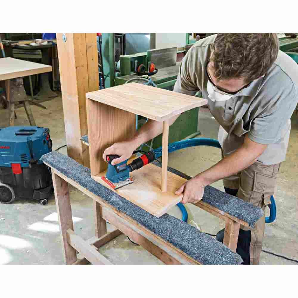 Bosch GSS20-40 2 Amp 1/4-Sheet Orbital Finishing Sander showing sanding wood cabinet with vacuum attachment (Sold Separately)