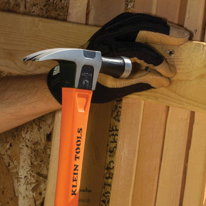 Klein Tools H80718 15 Inch 18oz Straight-Claw Electrician's Hammer showing in use driving a nail into a wood stud