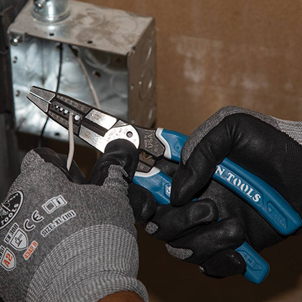 Klein Tools K12065CR Klein-Kurve Heavy-Duty Wire Stripper / Cutter / Crimper Multi Tool showing in use stripping electrical wires