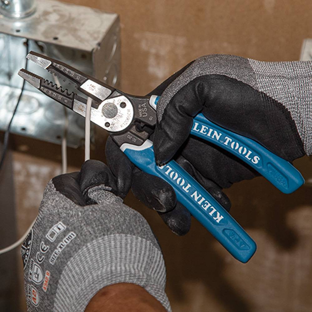 Klein Tools K12065CR Klein-Kurve Heavy-Duty Wire Stripper / Cutter / Crimper Multi Tool showing in use cutting electrical wires