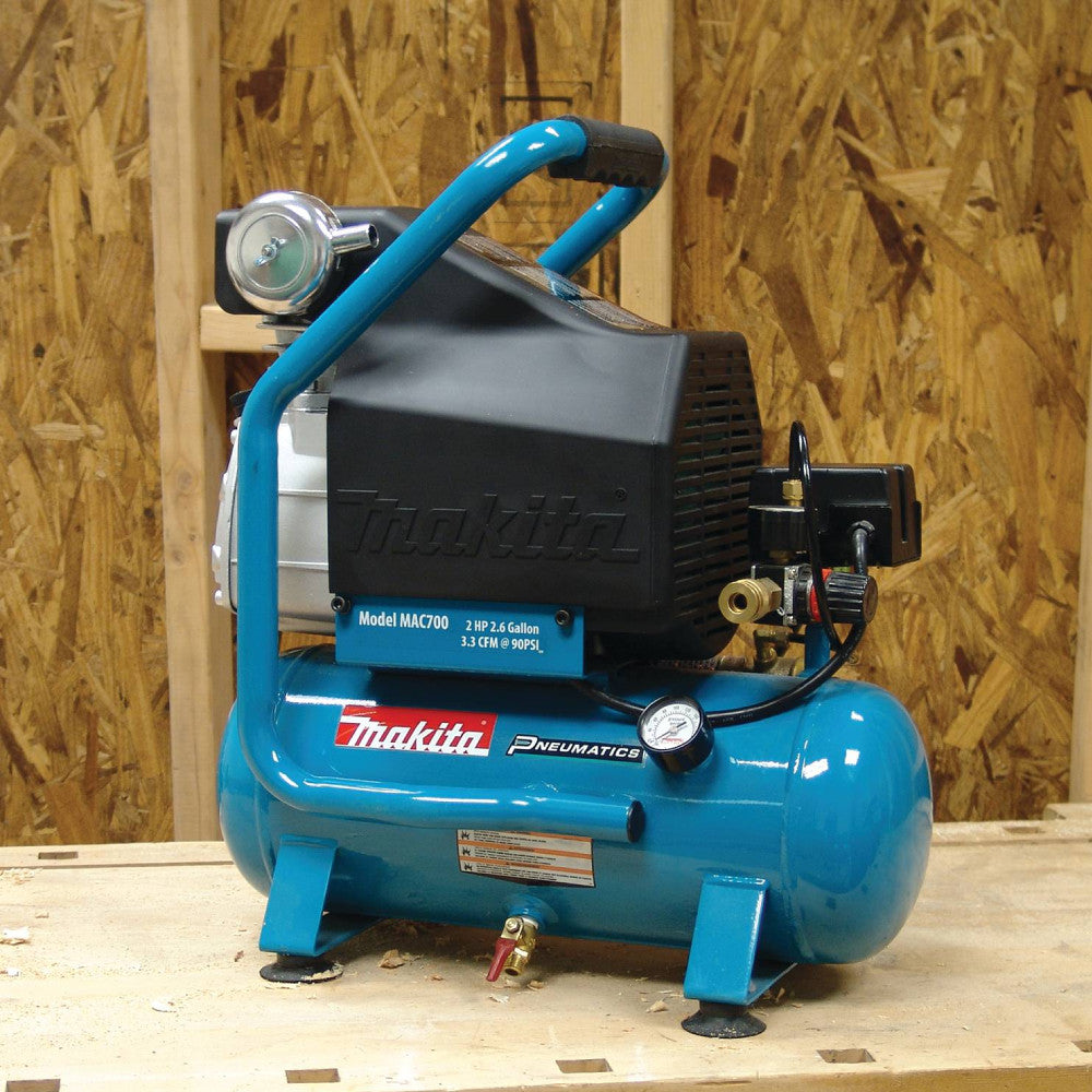 Makita MAC700 12.4 Amp 2 HP Big Bore 2.6 Gallon Air Compressor showing compressor seating on jobsite between usage