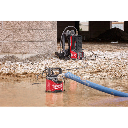 Milwaukee MXF211-1XC MX FUEL 1HP 2in Submersible Pump Kit showing in use pumping water out of a open pit of water