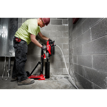 Milwaukee MXF301-2CXS MX FUEL Cordless Brushless Handheld Core Drill Kit with Stand showing in use coring a hole in concrete floor while mounted to the portable stand