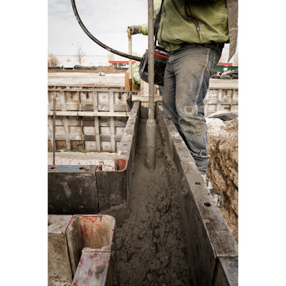 Milwaukee MXF370-2XC MX FUEL Cordless Brushless Concrete Vibrator Kit showing in use vibrating concrete for foundation with in form work