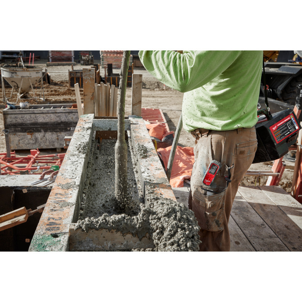Milwaukee MXF370-2XC MX FUEL Cordless Brushless Concrete Vibrator Kit showing in use vibrating concrete for foundation with in form work
