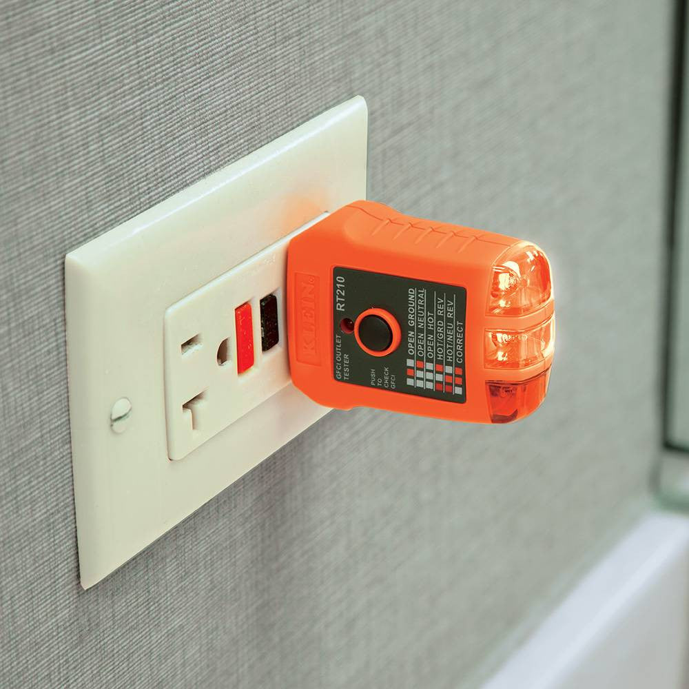 Klein Tools NCVT1XTKIT Non-Contact Voltage and GFCI Receptacle Premium Test Kit showing in use testing a interior outlet