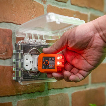 Klein Tools RT210 GFCI Receptacle Tester showing in use testing an exterior GFI plug