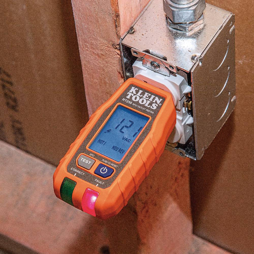 Klein Tools RT250 GFCI Receptacle Tester with LCD showing in use testing an interior electrical outlet