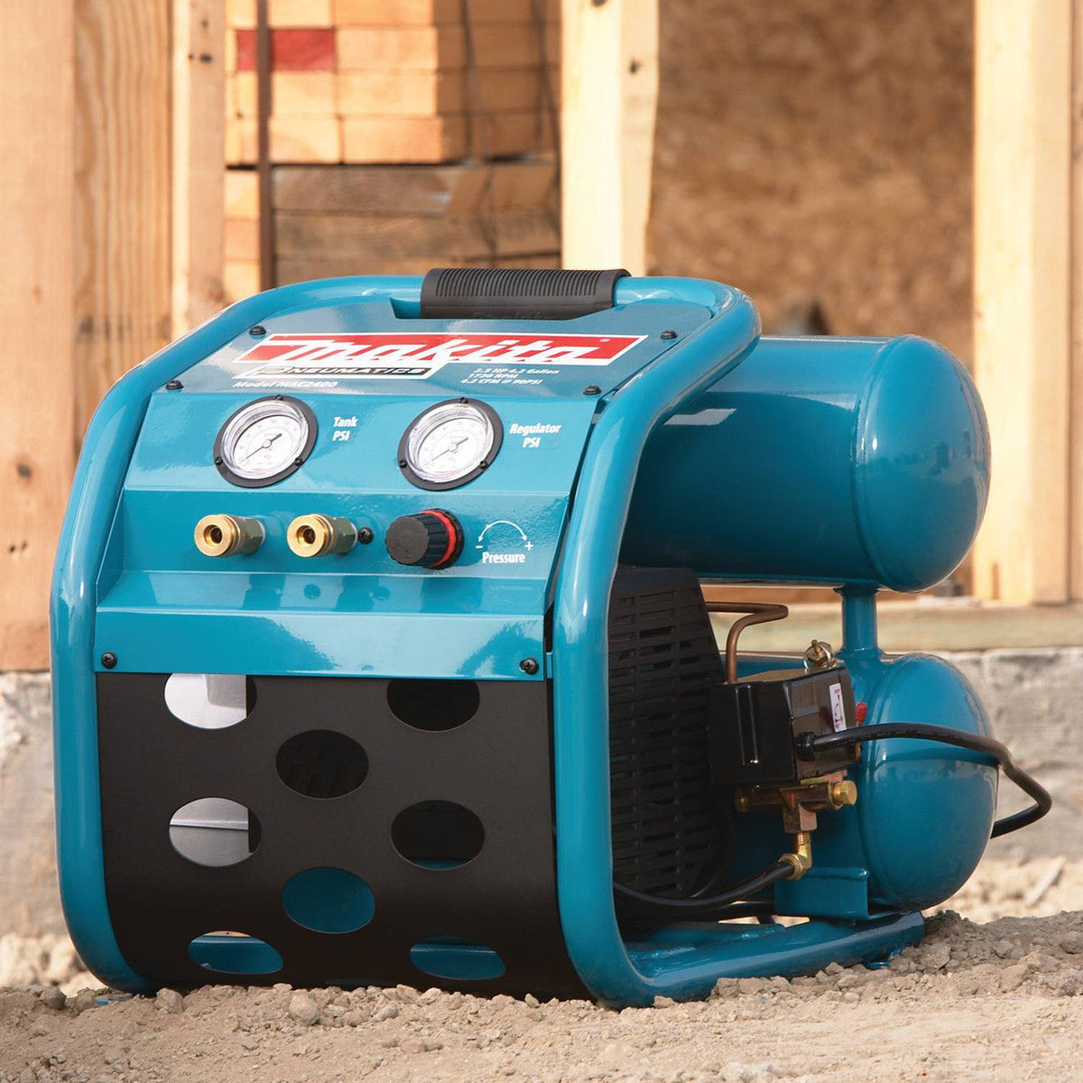 Makita MAC2400 12.3 Amp 2.5 HP Big Bore 4 Gallon Air Compressor showing compressor resting on a jobsite