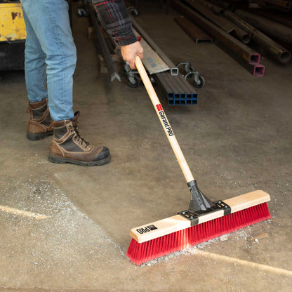 Garant Pro Series 24in Multi-Surface Push Broom with Wood Handle — in use sweeping a floor