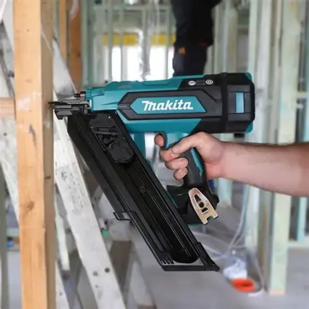 Makita DBN900ZK 18V LXT Cordless Brushless 3-1/2in 30° Framing Nailer (Tool Only) showing in use attaching cross bracing to a wood stud (Battery sold separately)
