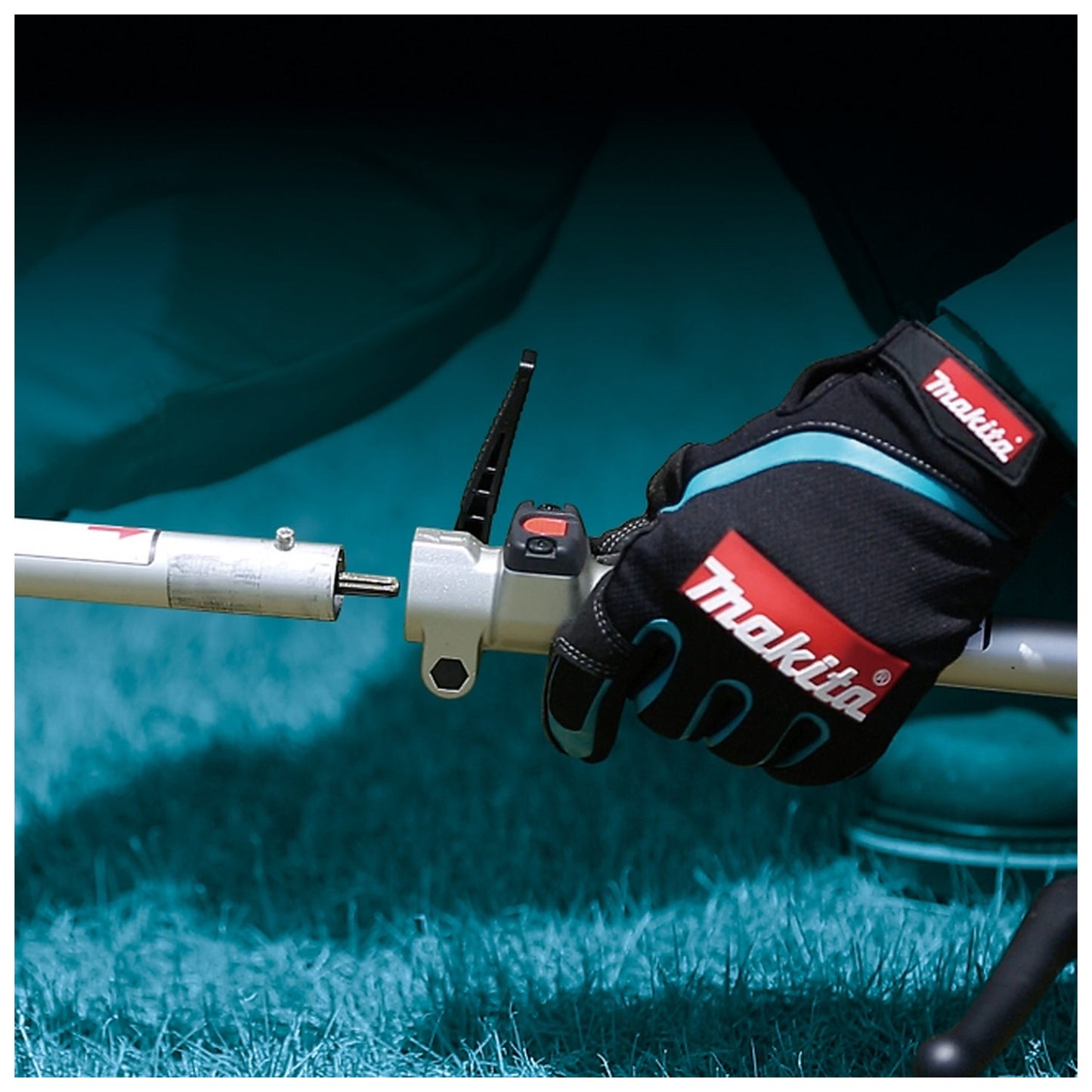 Makita DUX18Z lever-style attachment lock close-up in use
