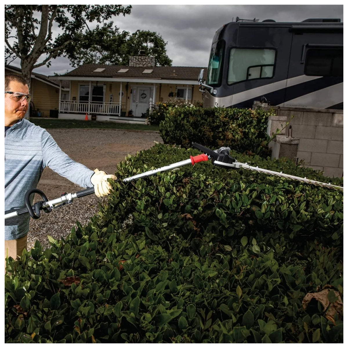 Makita DUX18Z power unit operating a hedge trimmer attachment