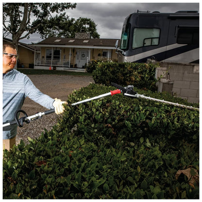 Makita DUX18Z power unit operating a hedge trimmer attachment