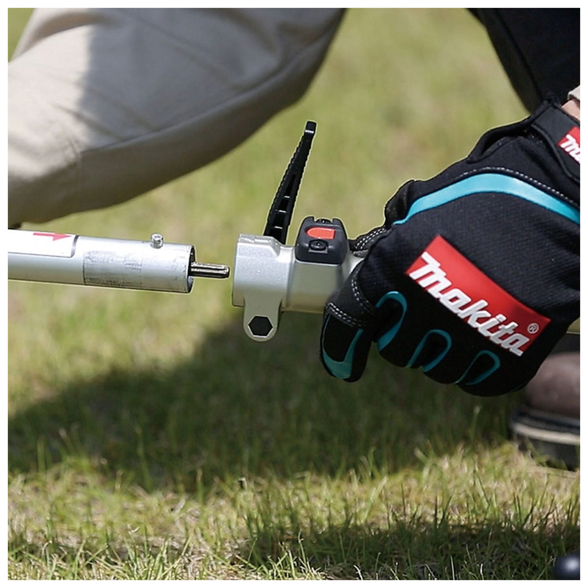 Makita DUX18Z lever-style attachment lock close-up outdoors