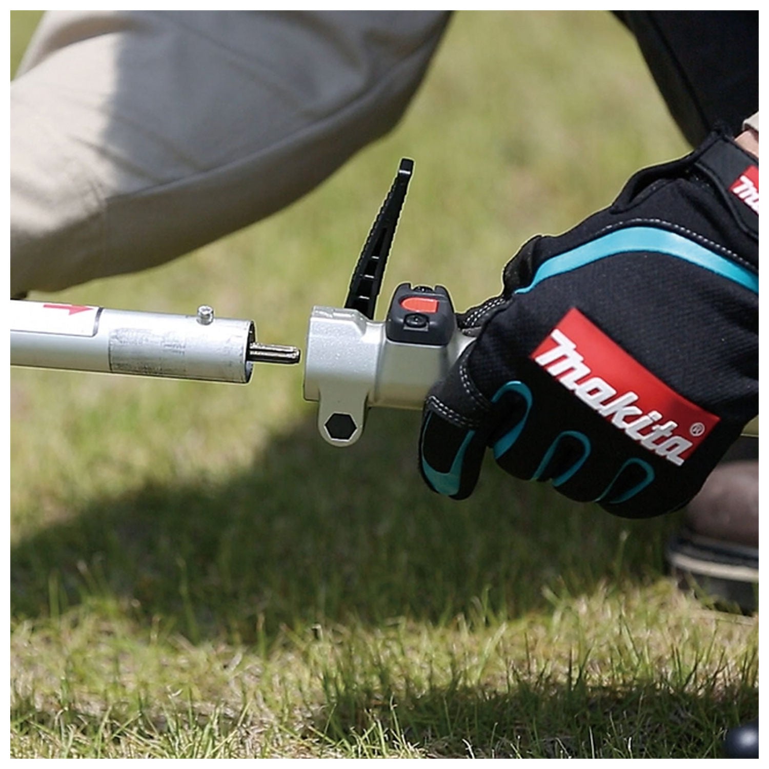 Makita DUX18Z lever-style attachment lock close-up outdoors