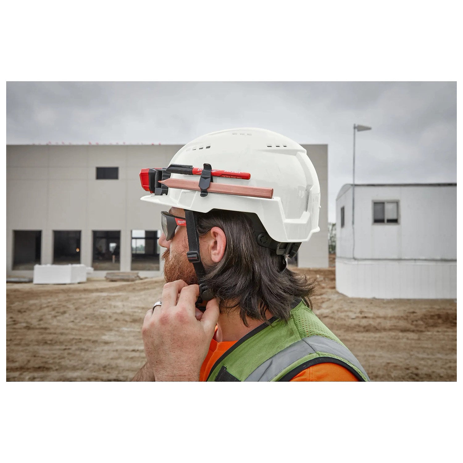 Milwaukee BOLT white vented safety helmet worn on a jobsite