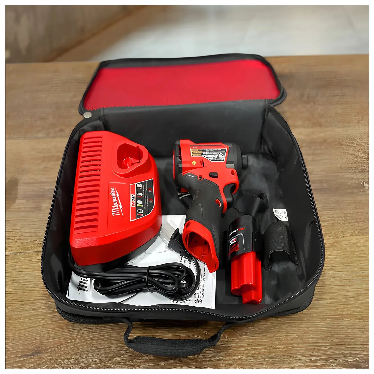 Milwaukee 3453-21 M12 FUEL impact driver kit with battery, charger, and contractor bag