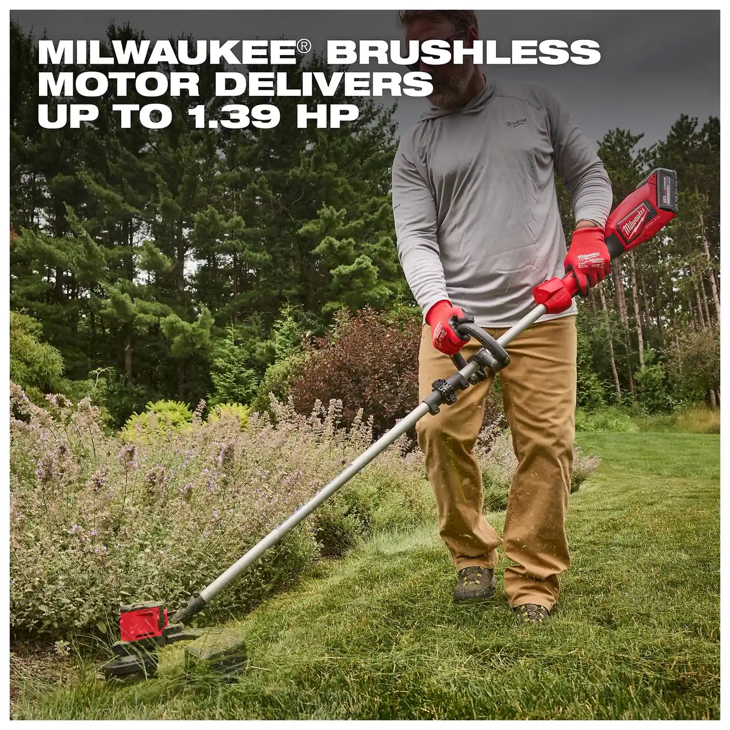 A person trims grass with the M18 Brushless String Trimmer, which has a powerful brushless motor delivering up to 1.39 horsepower. The trimmer features a red handle and is used in a well-maintained garden area surrounded by trees and shrubs.
